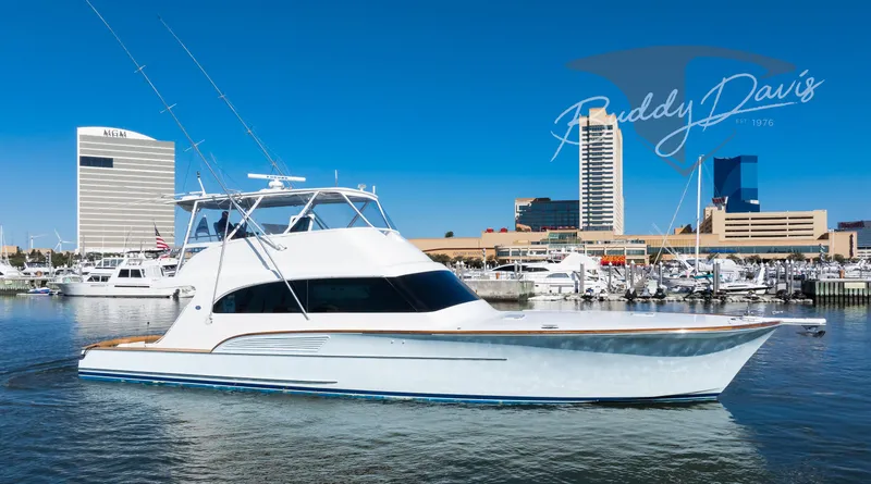Slide: The Image of 2009 Buddy Davis Sportfish yacht docked in harbor with city buildings. - 11