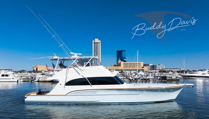 Slide: The Image of 2009 Buddy Davis Sportfish yacht docked in harbor under blue sky. - 13