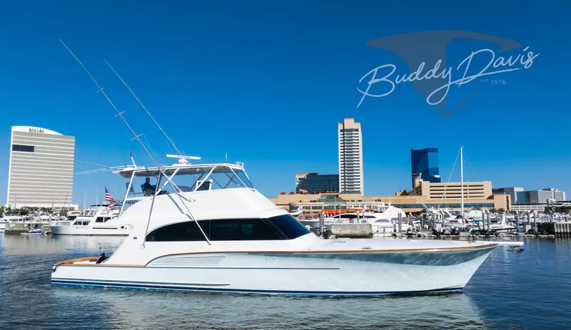 Slide: The Image of 2009 Buddy Davis Sportfish yacht in harbor with skyline backdrop. - 14