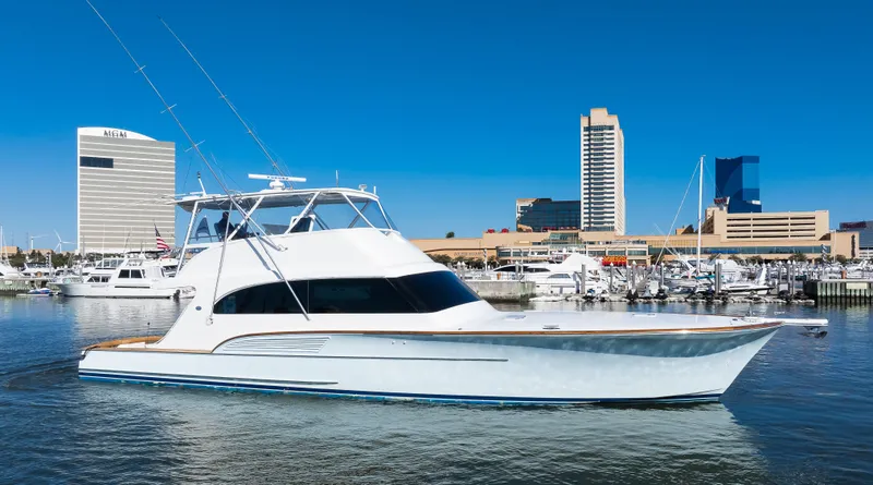 Slide: The Image of 2009 Buddy Davis Sportfish yacht in harbor with city buildings. - 2