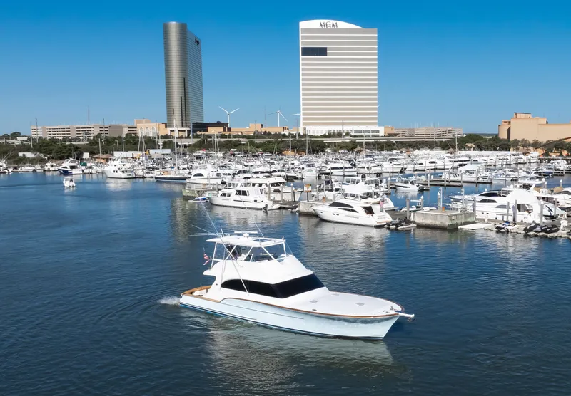 Slide: The Image of 2009 Buddy Davis Sportfish in harbor with skyscrapers in background. - 21
