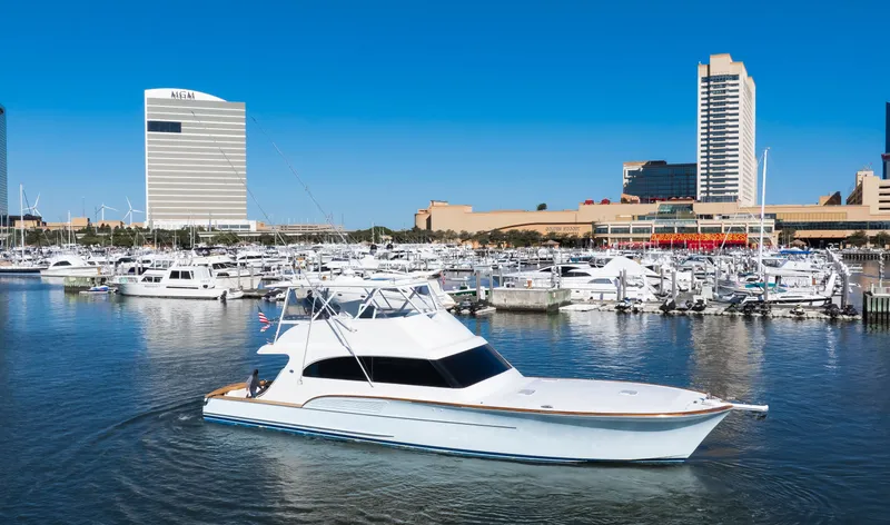 Slide: The Image of 2009 Buddy Davis Sportfish yacht in harbor with skyscrapers. - 22