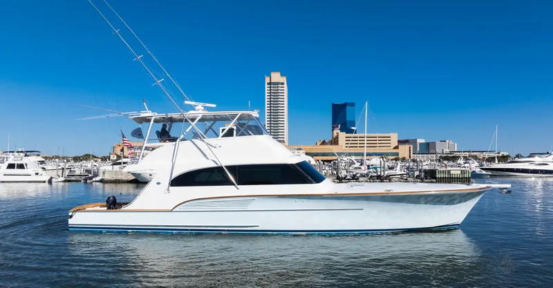 Slide: The Image of 2009 Buddy Davis Sportfish yacht docked in harbor with city skyline. - 24