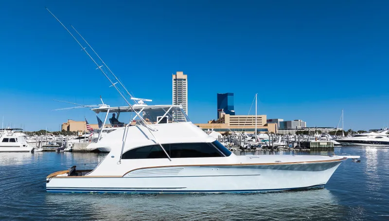 Slide: The Image of 2009 Buddy Davis Sportfish yacht docked in harbor with city skyline. - 4