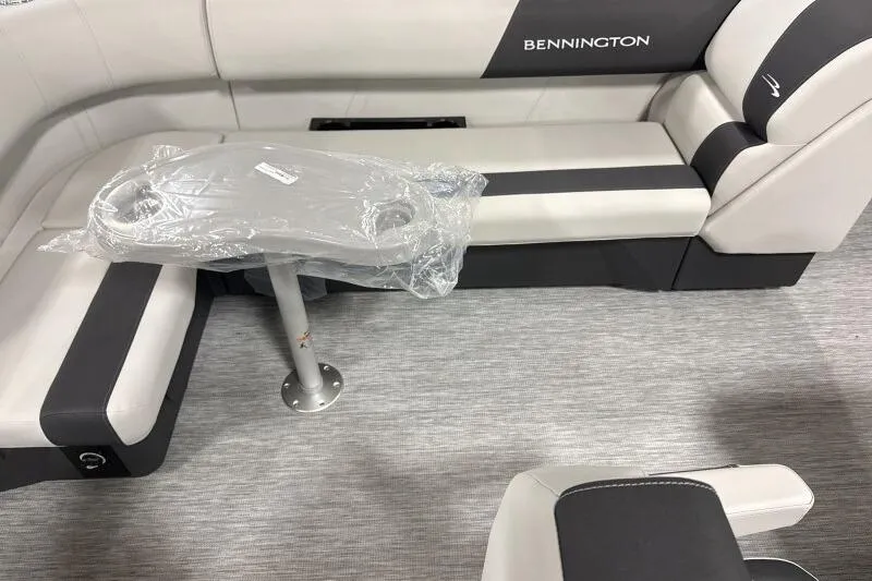 Slide: The Image of 2026 Bennington 20 SLSF boat interior with seating and table, wrapped in plastic. - 10