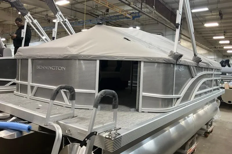 Slide: The Image of 2026 Bennington 20 SLSF pontoon boat with canopy in a factory setting. - 19