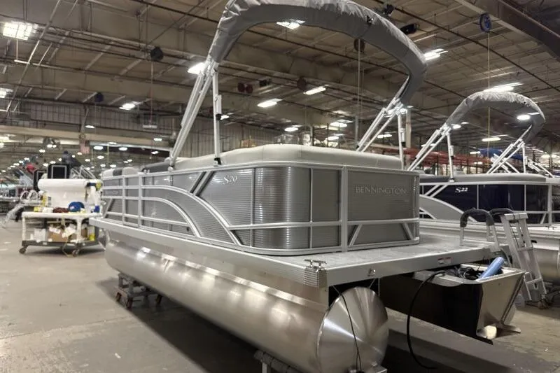 Slide: The Image of 2026 Bennington 20 SLSF pontoon boat in a factory setting. - 5