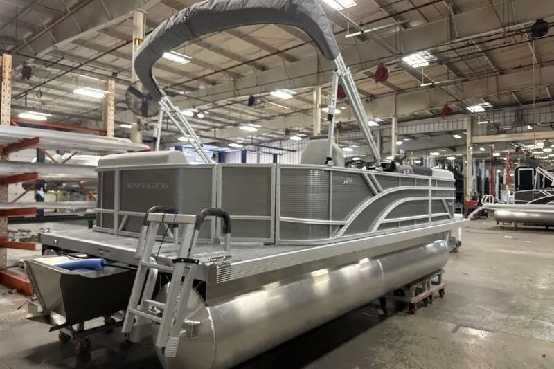 Slide: The Image of 2026 Bennington 20 SLSF pontoon boat in a factory setting. - 6