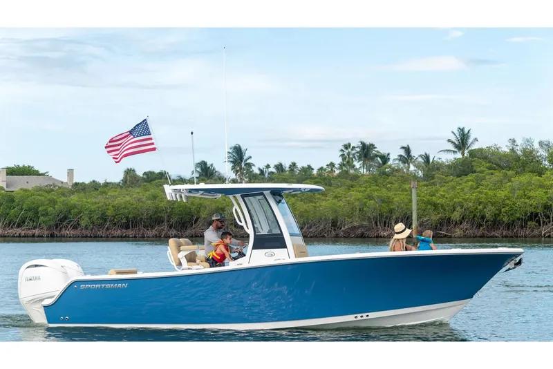 The Image of Manufacturer Provided Image: 2025 Sportsman Open 252 Center Console boat cruising with passengers, American flag waving. - 0
