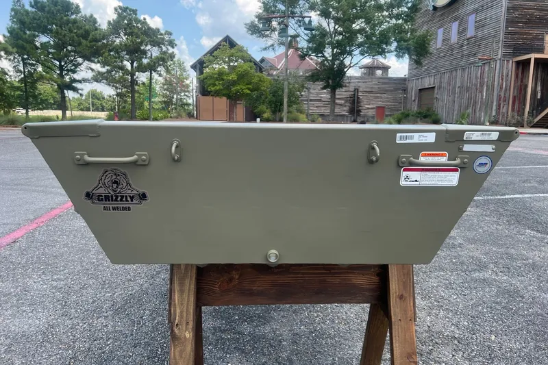 Slide: The Image of Tracker Grizzly 12 Jon boat, 2026 model, displayed outdoors on a wooden stand. - 3