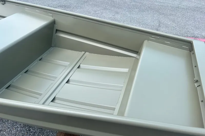 Slide: The Image of 2026 Tracker Grizzly 12 Jon boat interior, showcasing durable seating and flooring. - 6