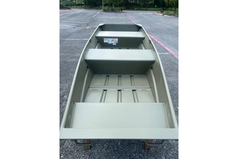 Slide: The Image of 2026 Tracker Grizzly 12 Jon boat, empty interior view, parked on asphalt. - 5