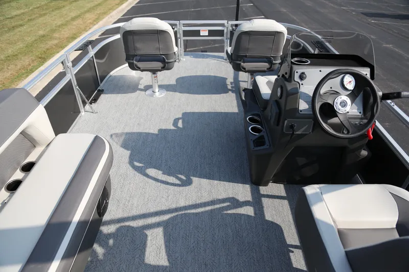 Slide: The Image of 2026 Sun Tracker Bass Buggy 16 XL Select pontoon boat interior with seating and steering console. - 5