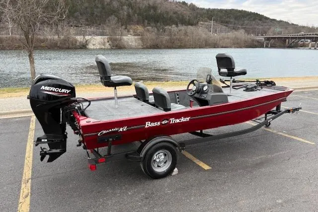 Slide: The Image of 2026 Tracker Bass Tracker Classic XL boat with Mercury engine by a lake. - 81