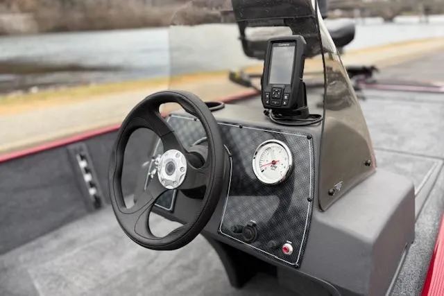 Slide: The Image of 2026 Tracker Bass Tracker Classic XL boat dashboard with steering wheel and navigation system. - 82