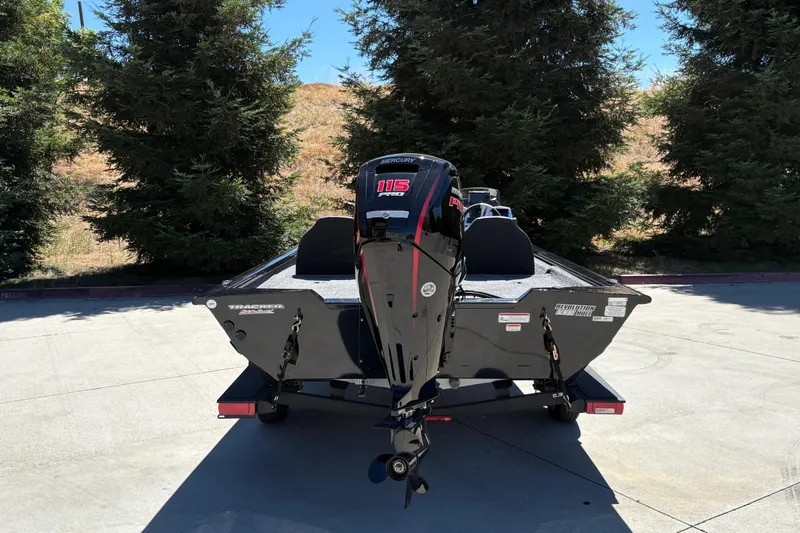 Slide: The Image of 2026 Tracker Pro Team 190 boat with Mercury engine, parked outdoors. - 10