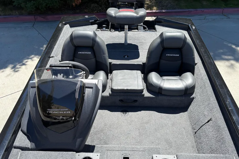 Slide: The Image of 2026 Tracker Pro Team 190 boat interior with black seating and steering console. - 18