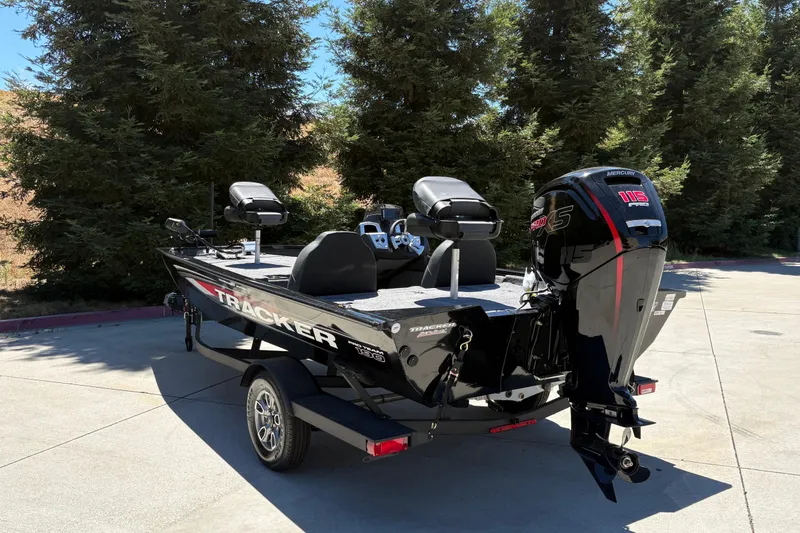 Slide: The Image of 2026 Tracker Pro Team 190 boat with Mercury 115 Pro XS engine, parked outdoors. - 8