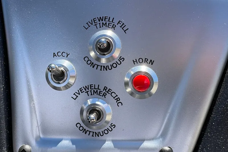 Slide: The Image of Control panel of 2026 Tracker Pro Team 190 boat with switches and horn button. - 25