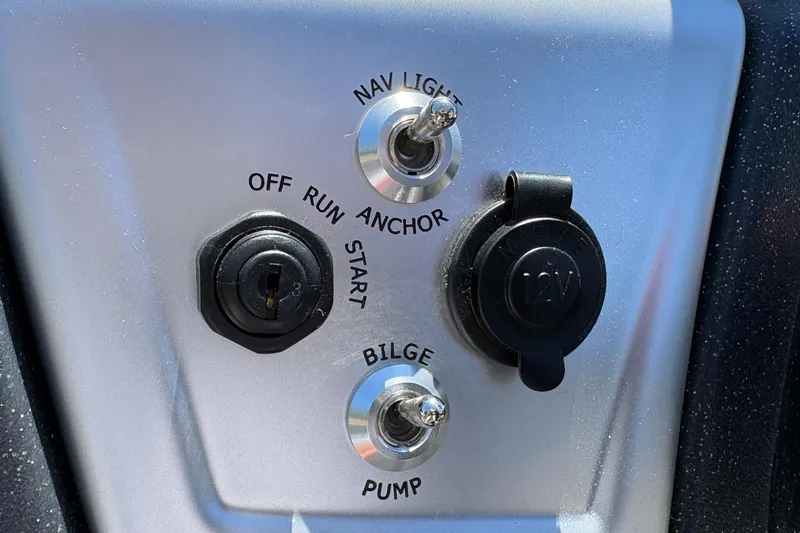 Slide: The Image of Control panel of 2026 Tracker Pro Team 190 boat with switches and ignition. - 24
