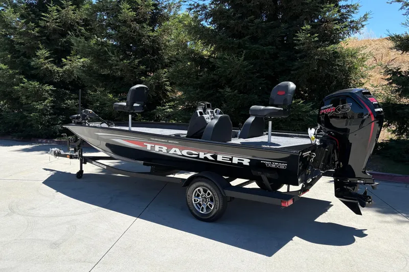 Slide: The Image of 2026 Tracker Pro Team 190 boat with Mercury Pro XS engine, parked outdoors. - 2