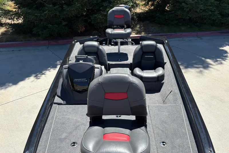 Slide: The Image of 2026 Tracker Pro Team 190 boat interior with black and red seating. - 19