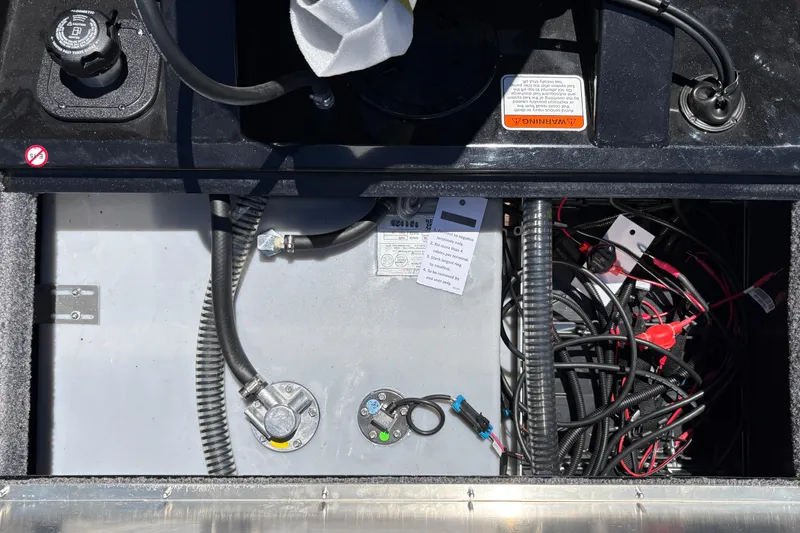 Slide: The Image of 2026 Tracker Pro Team 190 boat wiring and fuel system components in storage compartment. - 26