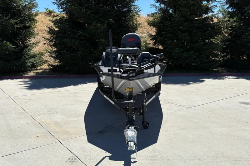 Slide: The Image of 2026 Tracker Pro Team 190 boat parked on concrete, surrounded by trees. - 11