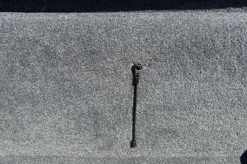 Slide: The Image of Carpeted interior of 2026 Tracker Pro Team 190 boat with a mounted support rod. - 22