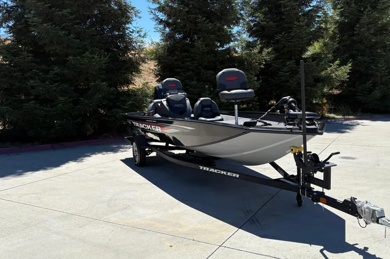 Slide: The Image of 2026 Tracker Pro Team 190 boat on trailer, parked outdoors near trees. - 4