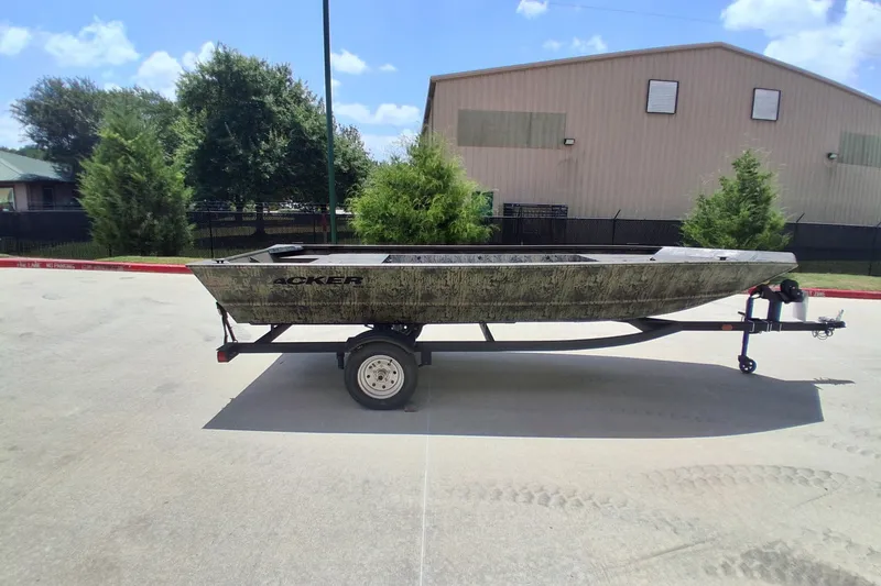 The Image of 2026 Tracker Grizzly 1648 Utility boat on trailer, parked outdoors. - 0