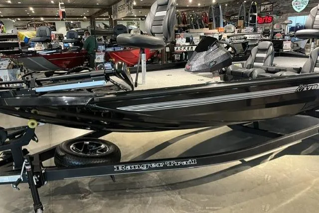 Slide: The Image of 2026 Ranger RT178 boat on display in a showroom, featuring sleek design and modern seating. - 2