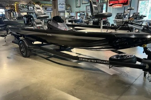 Slide: The Image of 2026 Ranger RT178 boat in showroom, featuring sleek black design and modern seating. - 1
