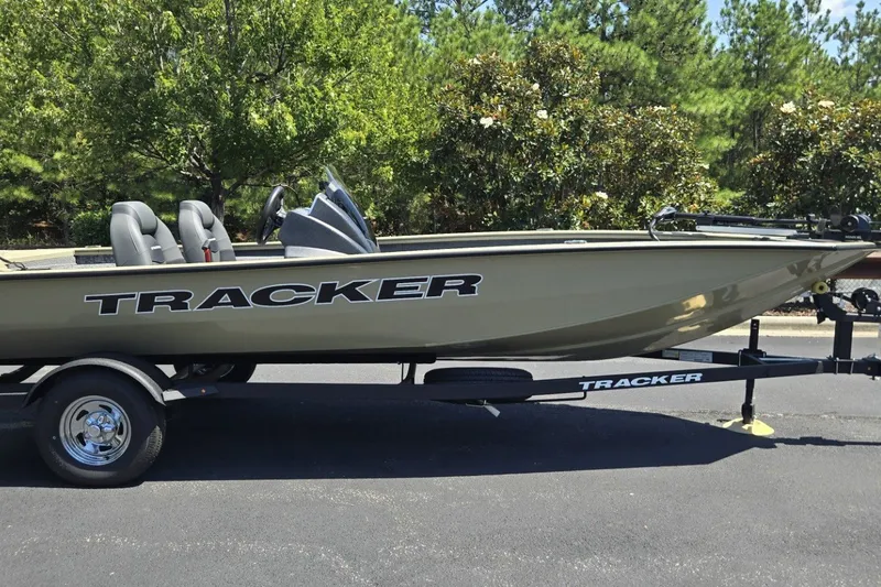 The Image of 2026 Tracker Pro Team 190 boat on trailer, parked outdoors with trees in background. - 0