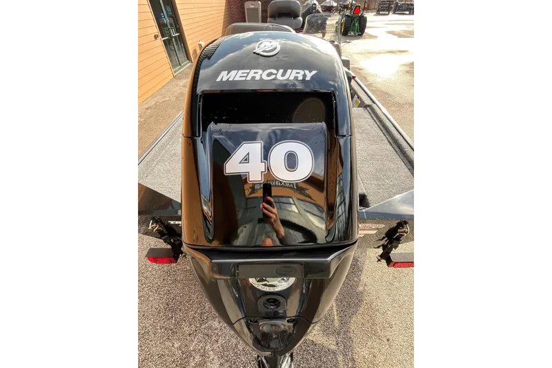 Slide: The Image of 2026 Tracker Bass Tracker Classic XL with Mercury 40 HP engine, parked outdoors. - 2