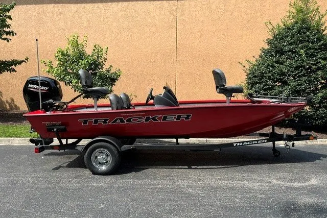 The Image of 2026 Tracker Pro Team 175 boat on trailer, red exterior, parked outdoors. - 0