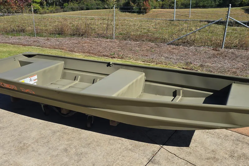 Slide: The Image of 2026 Tracker Grizzly 14 Jon boat on pavement, with grassy field background. - 3