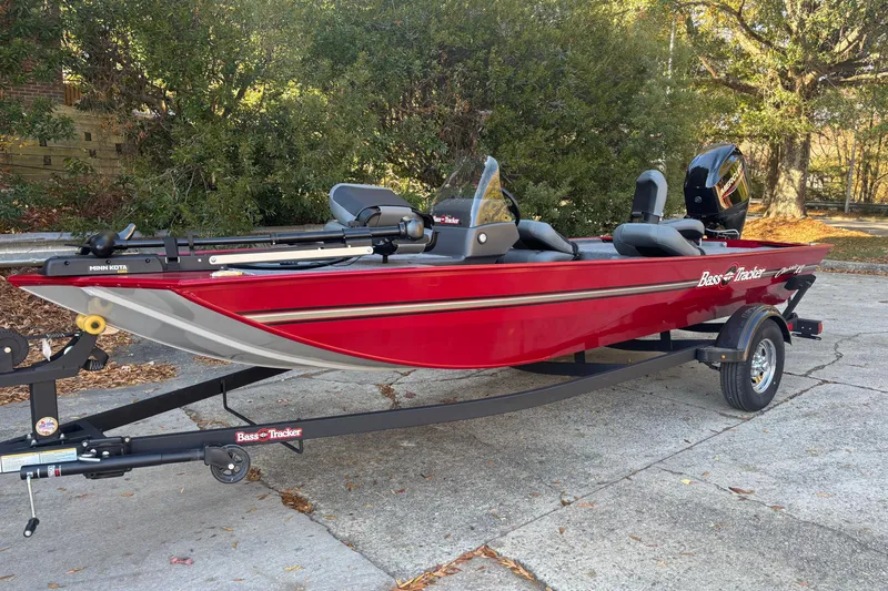 Slide: The Image of 2026 Tracker Bass Tracker Classic XL boat on trailer, red exterior, parked outdoors. - 3