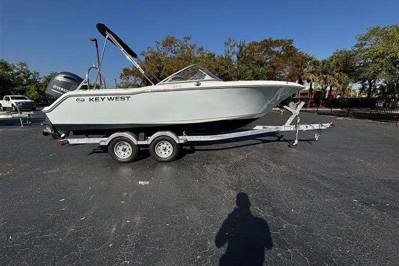 The Image of 2023 Key West 203 DFS boat on trailer in parking lot, clear sky background. - 0