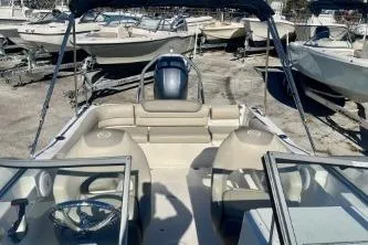 Slide: The Image of 2023 Key West 203 DFS boat with open seating, parked among other boats. - 11