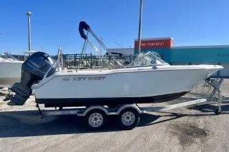 Slide: The Image of 2023 Key West 203 DFS boat on trailer, parked outdoors. - 3