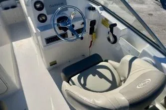 Slide: The Image of 2023 Key West 203 DFS boat cockpit with steering wheel and comfortable seating. - 9
