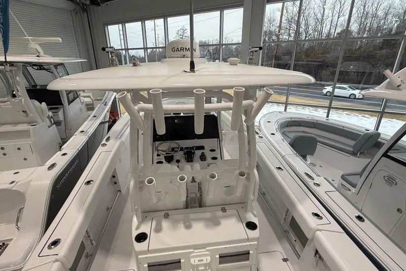 Slide: The Image of 2026 Sportsman Open 282 Center Console boat interior with rod holders and helm station. - 11