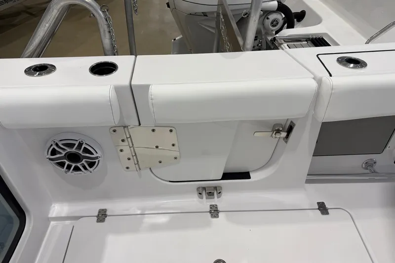 Slide: The Image of 2026 Sportsman Open 282 Center Console boat interior with speaker and storage compartment. - 14
