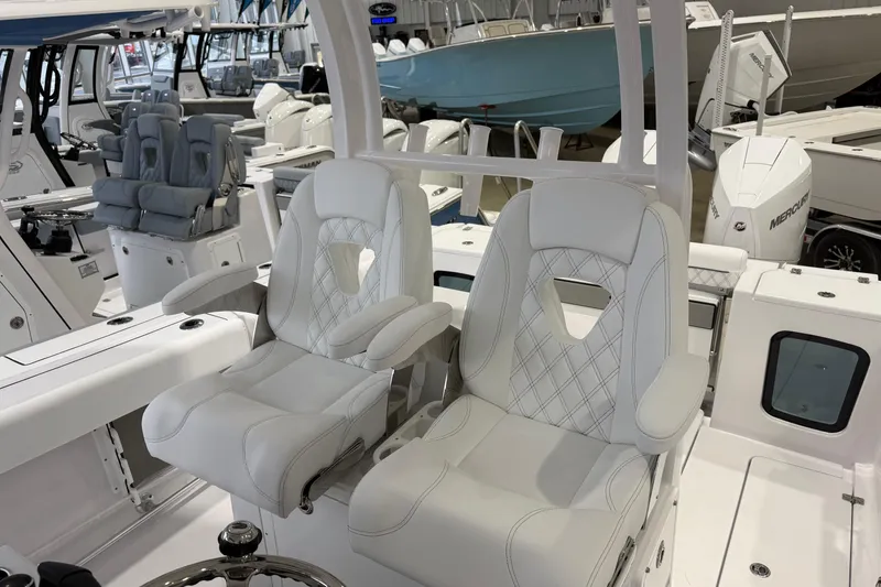 Slide: The Image of 2026 Sportsman Open 282 Center Console with luxurious white seating in a showroom. - 15