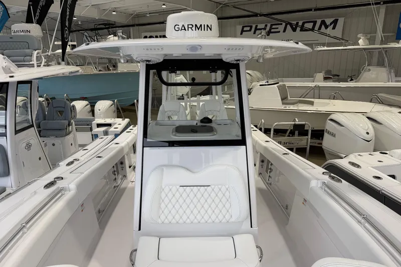 Slide: The Image of 2026 Sportsman Open 282 Center Console boat in showroom, featuring Garmin electronics. - 16