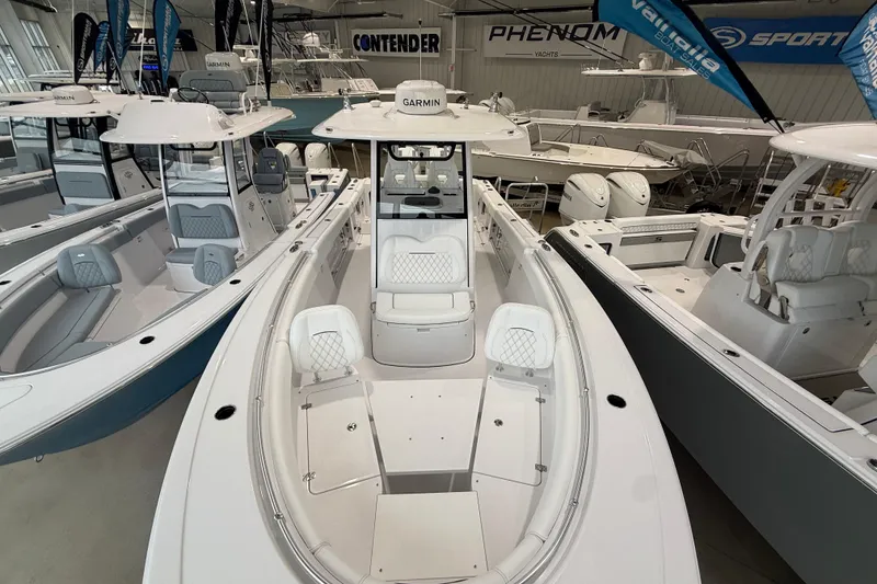 Slide: The Image of 2026 Sportsman Open 282 Center Console boat displayed in a showroom. - 17