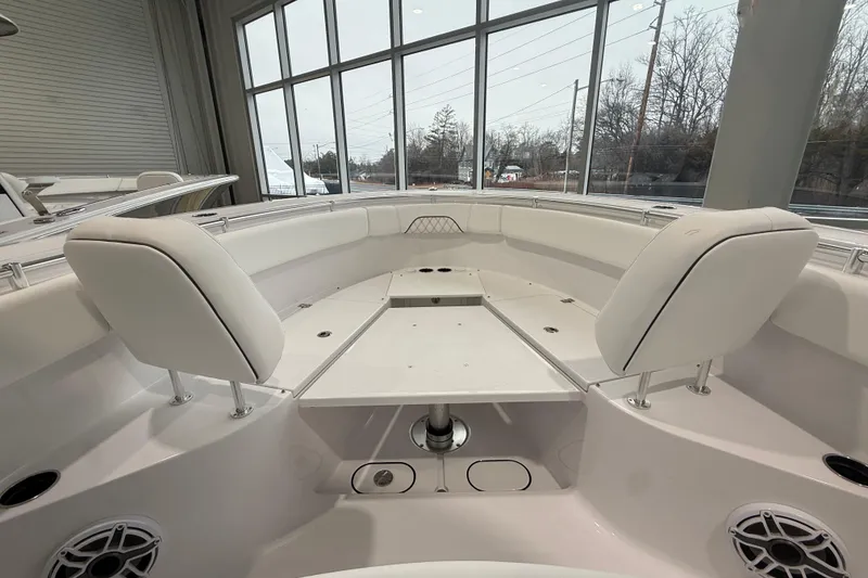 Slide: The Image of 2026 Sportsman Open 282 Center Console boat interior with seating and table. - 18