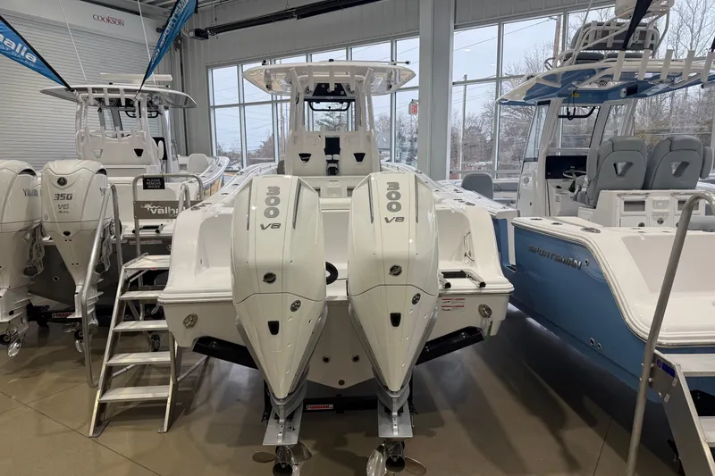 Slide: The Image of 2026 Sportsman Open 282 Center Console boat with twin 300 V8 engines in showroom. - 2