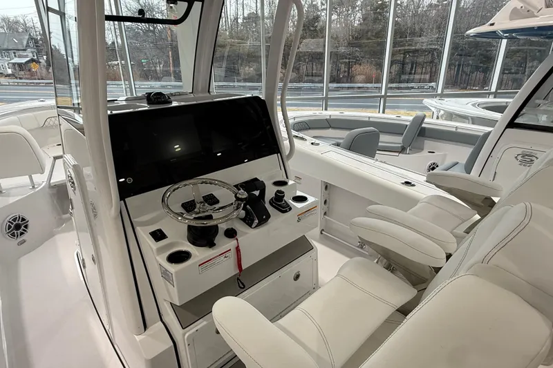 Slide: The Image of 2026 Sportsman Open 282 Center Console boat interior with modern helm and seating. - 3